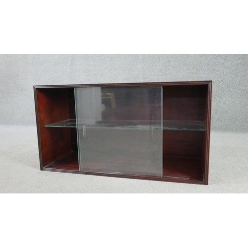 298 - A circa 1970s fruitwood side cabinet, of rectangular form with two glass sliding doors, enclosing an... 