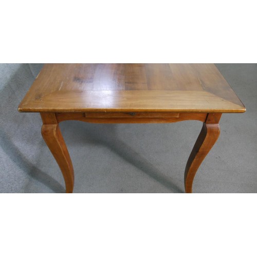 11 - A 19th century French cherrywood farmhouse dining table, the rectangular cleated plank top over an e... 