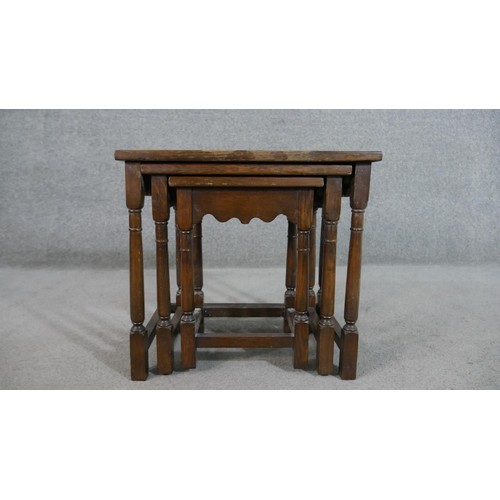 216 - A nest of three 17th century style oak graduating rectangular tables, on turned legs. H. 48 W.52 D.3... 