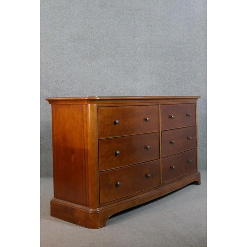 299 - A Victorian style fruitwood bow front chest, with two banks of three drawers with knob handles, on a... 