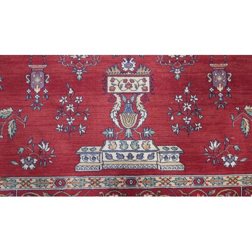 301 - A woollen Keshan motif carpet, on a red ground. L.290 W.200cm.