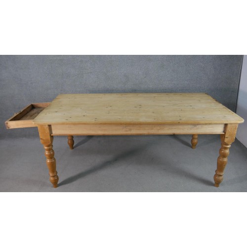 316 - A Victorian pine planked top kitchen table, with an end drawer, on turned legs. H.75 W.186 D.97cm