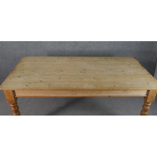 316 - A Victorian pine planked top kitchen table, with an end drawer, on turned legs. H.75 W.186 D.97cm