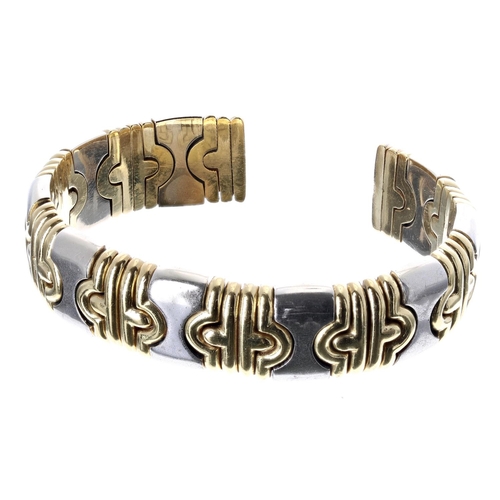 119 - 18ct bicolour sprung bangle, 75.8gm (327)