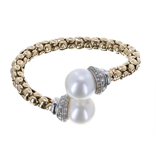 167 - Good 18k yellow gold pearl and diamond sprung bangle, the pearl terminals each of good lustre measur... 