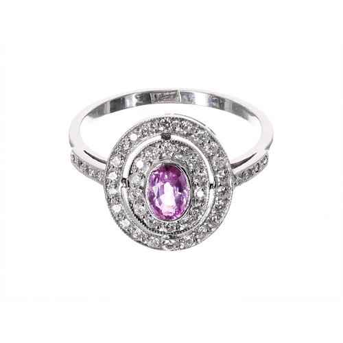 183 - Pretty 18ct white gold pink sapphire and diamond halo set oval cluster ring, the sapphire .36ct, in ... 