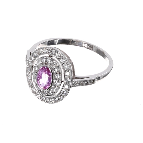 183 - Pretty 18ct white gold pink sapphire and diamond halo set oval cluster ring, the sapphire .36ct, in ... 