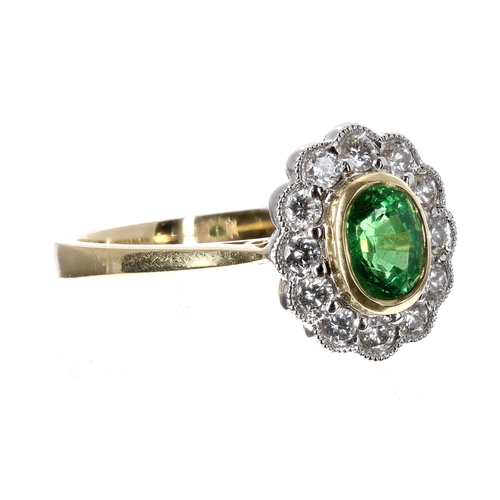 186 - 18ct green garnet and diamond oval cluster ring, the garnet 0.82ct approx in a setting of round bril... 