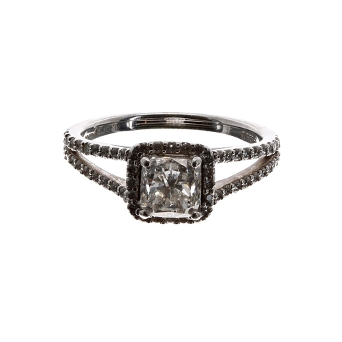 68 - Attractive platinum diamond set ring, halo set with modified cushion-cut diamond and two-row split s... 