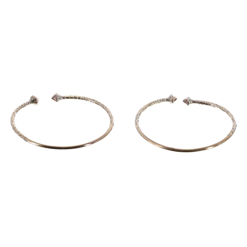 89 - Two yellow metal patterned torque bangles, 28gm (2) (251)