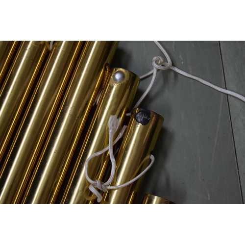 1309 - Set of nine large brass tubular bells within a soft bag