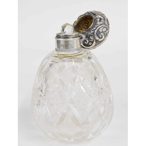 269 - Edward VII silver mount glass scent bottle, the repousse scrolling decorated hinged cover over an in... 