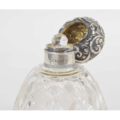 269 - Edward VII silver mount glass scent bottle, the repousse scrolling decorated hinged cover over an in... 