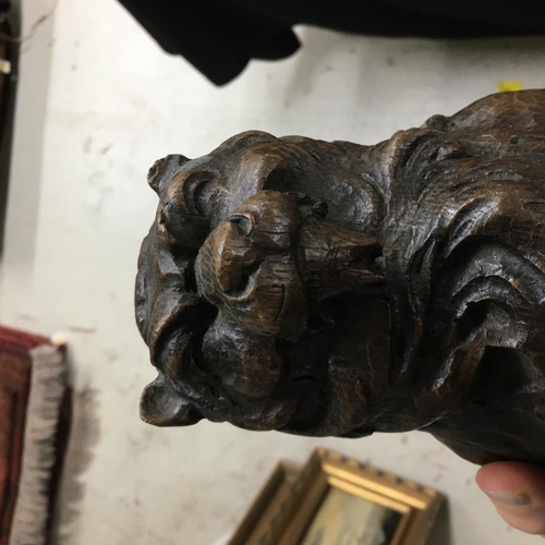 318 - 17th century carved oak lion, modelled holding a scrolling shield, 14