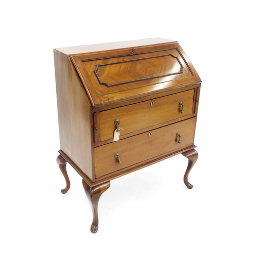 209 - Mahogany bureau, the panelled fall front enclosing a fitted interior over two drawers and upon cabri... 