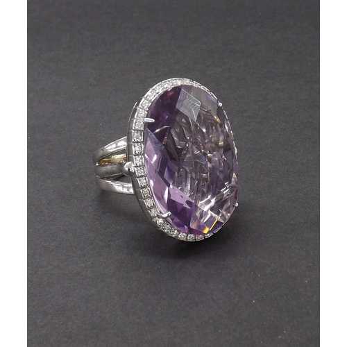 26 - Fiorelli 18ct white gold large cocktail ring, the oval facet cut amethyst within a surround of round... 