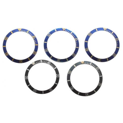 603 - Rolex - two black bezel inserts; together with three blue bezel inserts (5)