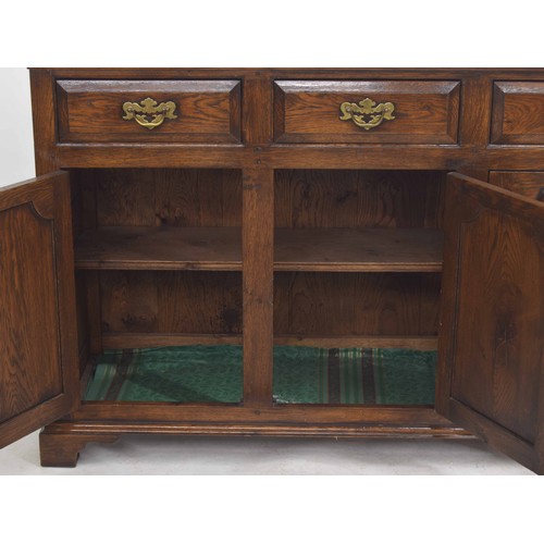 355 - Georgian style oak dresser base, the moulded top over three short drawers and three panelled cupboar... 