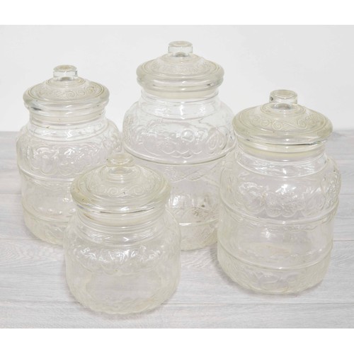 192 - Four moulded glass storage jars, tallest 12.5