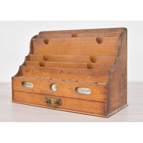 193 - Early 20th century oak stationary rack, inset with reel scroll day/date apertures over a single draw... 