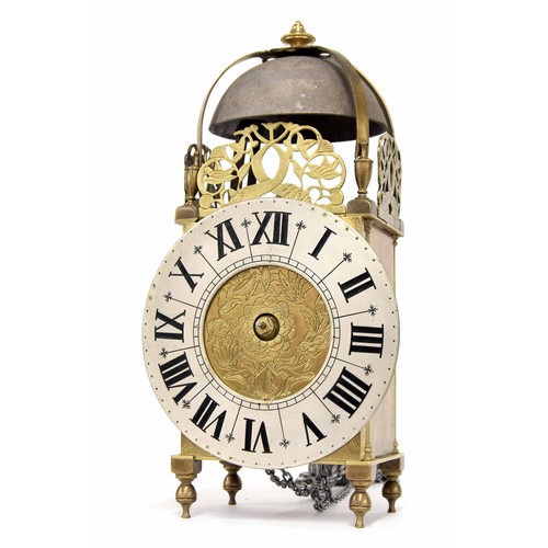 1344 - Continental brass lantern clock, the 6.75” silvered dial enclosing a foliate engraved centre, surmou... 