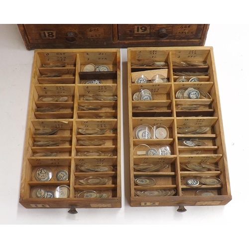 507 - Twenty four drawer wooden chest containing a large quantity of watch glasses, various sizes 94-428, ... 