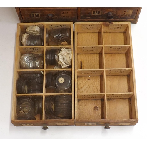 507 - Twenty four drawer wooden chest containing a large quantity of watch glasses, various sizes 94-428, ... 