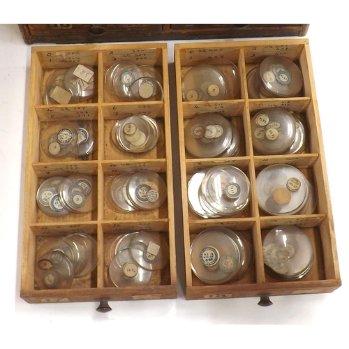 507 - Twenty four drawer wooden chest containing a large quantity of watch glasses, various sizes 94-428, ... 