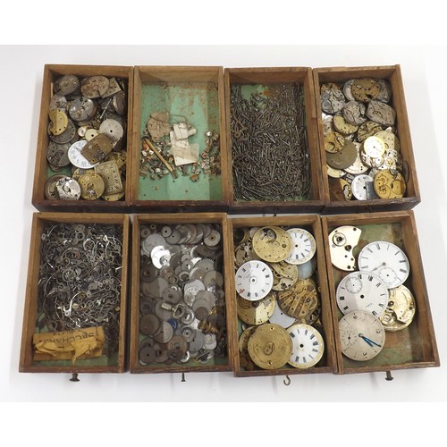 607 - Selection of watch parts contained within four chests to include dials, crowns, pocket watch buttons... 