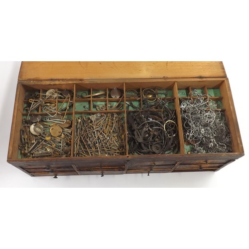 607 - Selection of watch parts contained within four chests to include dials, crowns, pocket watch buttons... 