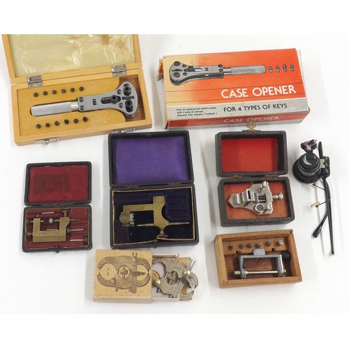 623 - Selection of cased watchmakers tools to include a wristwatch case opener, poising tool, magnifier et... 