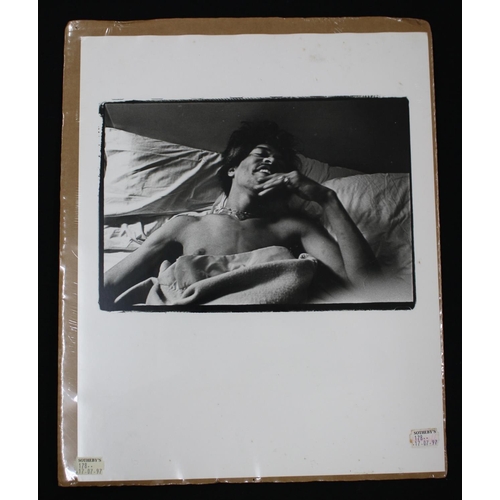 553 - Jimi Hendrix - black and white photographic print of Jimi Hendrix in bed, possibly unseen, bearing S... 