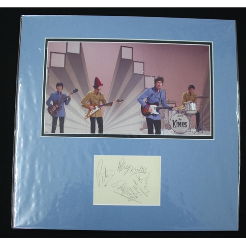 566 - The Kinks - autographed display mounted below a picture of the band, 15.5