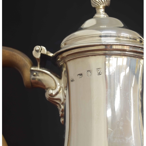 505 - George III silver pear shaped coffee pot, with a fruitwood handle and hinged cover and a spiral flut... 