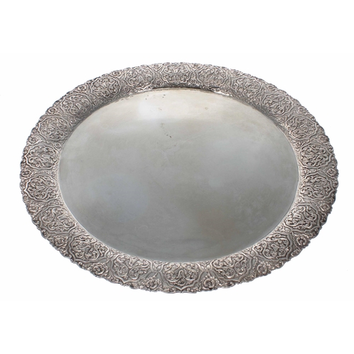 587 - Large Greek white metal (900) circular serving tray, with a stylised arabesque embossed wide rim, ma... 