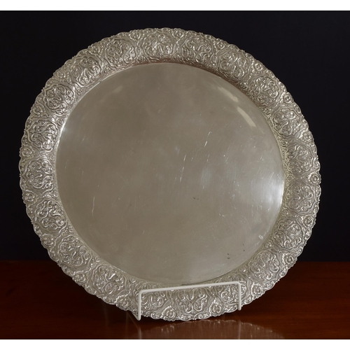 587 - Large Greek white metal (900) circular serving tray, with a stylised arabesque embossed wide rim, ma... 