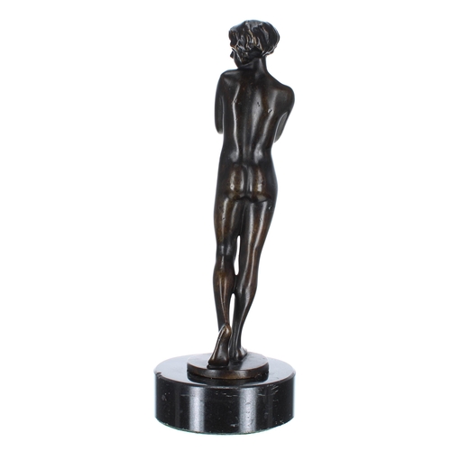 642 - Art Deco figural bronze female nude, modelled standing mounted upon a circular marble socle, 11