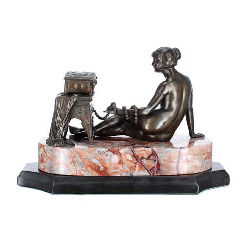 643 - Art Deco bronze figure of a reclining nude by a decorative table with jewellery box and pearls, moun... 