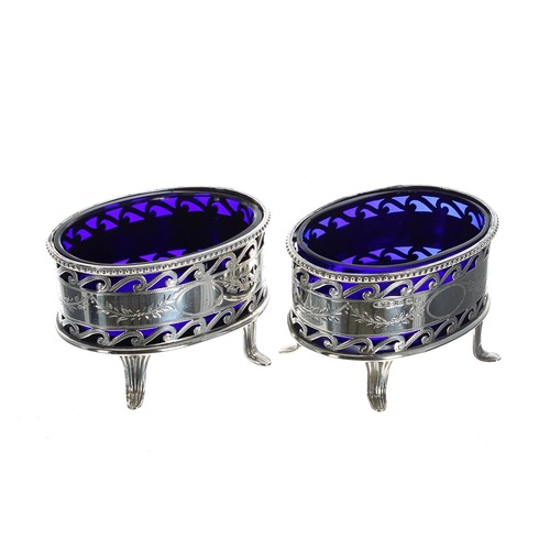 595 - Pair of George V silver open salts, the scrolling pierced baskets with engraved foliate swag borders... 