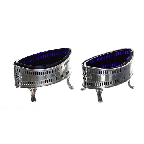 596 - Matched pair of Edwardian silver open salts, the pierced boat shaped baskets raised on four feet enc... 