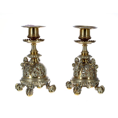 657 - Pair of 19th Century brass candlesticks, with circular sconces over serrated drip pans, raised on pi... 