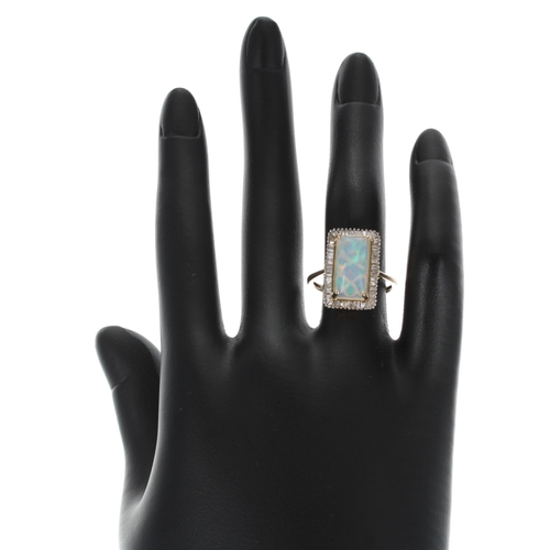 171 - Attractive modern 9ct yellow gold opal and diamond ring, the cabouchon opal in a surround of baguett... 