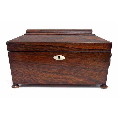 622 - Regency rosewood tea caddy of sarcophagus form with ring handles, the hinged cover enclosing two hin... 