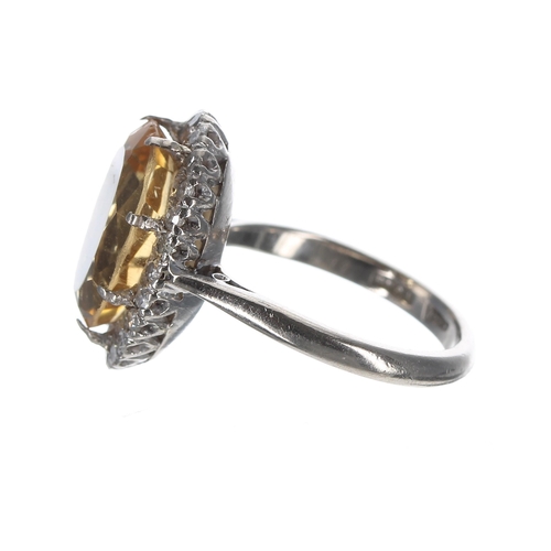 103 - Platinum citrine and diamond oval ring, the citrine 4.15ct approx, in a surround of round-cut diamon... 