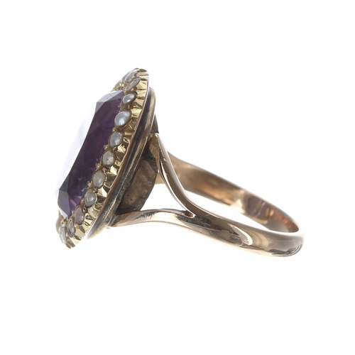 86 - Amethyst and pearl oval cluster ring, the amethyst 6.40ct approx, in a band of seed pearl set in yel... 