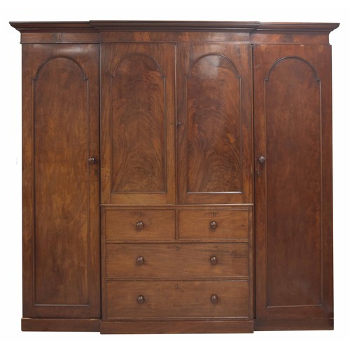 961 - Victorian mahogany breakfront triple robe, surmounted by a moulded cornice over central cupboard doo... 