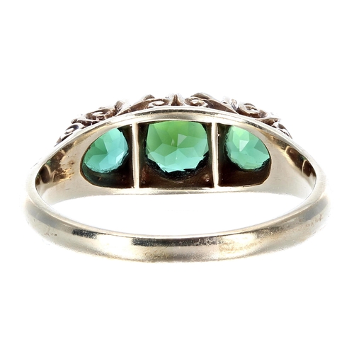 413 - Green tourmaline 9ct three stone ring with a carved scroll setting, width 7mm, 3.6gm, ring size Q... 