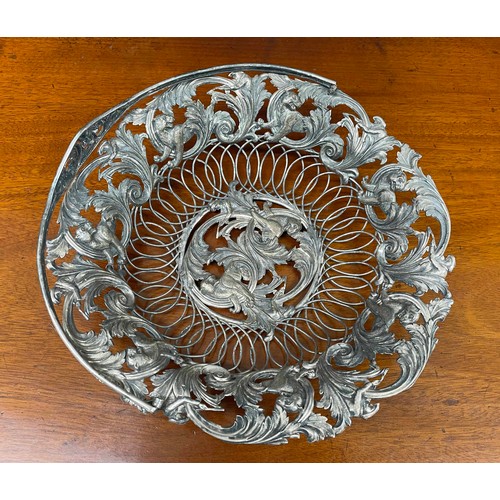 609 - Decorative Indian open work white metal basket, with a scrolling foliate outer rim border with hunte... 