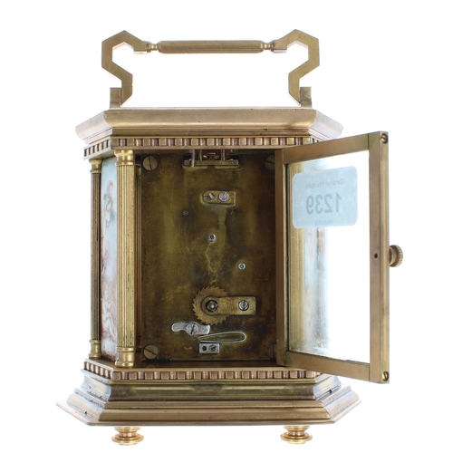 1239 - Contemporary porcelain panelled carriage clock, within an hexagonal case painted with a floral lands... 