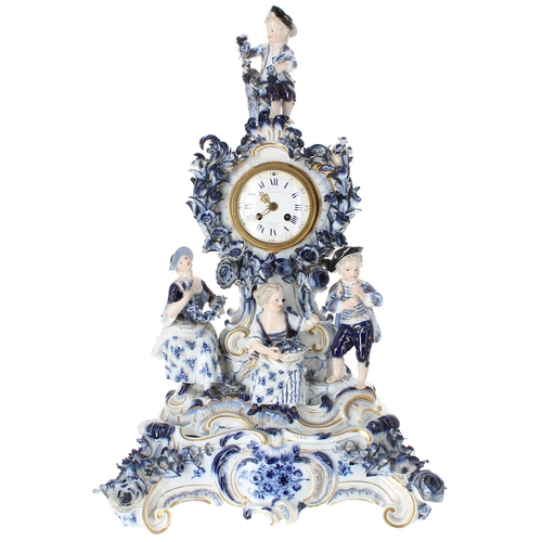 1506 - Good German blue and white porcelain figural mantel clock bearing the cross swords mark, the 2.5